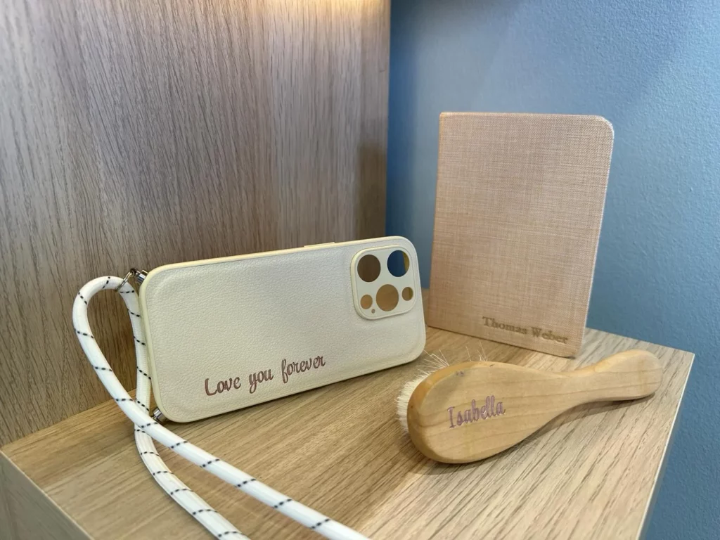 Foil stamping on multiple items – wooden comb, fabric book cover, and phone case