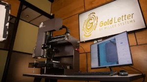 The embossing machine and operating computer on an office desk