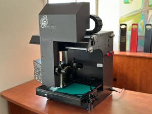 Gold Letters digital embossing and foil stamping machine in a studio workspace.